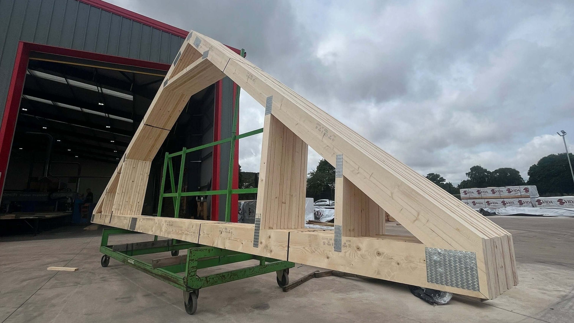 attic trusses on a rack outside a factory