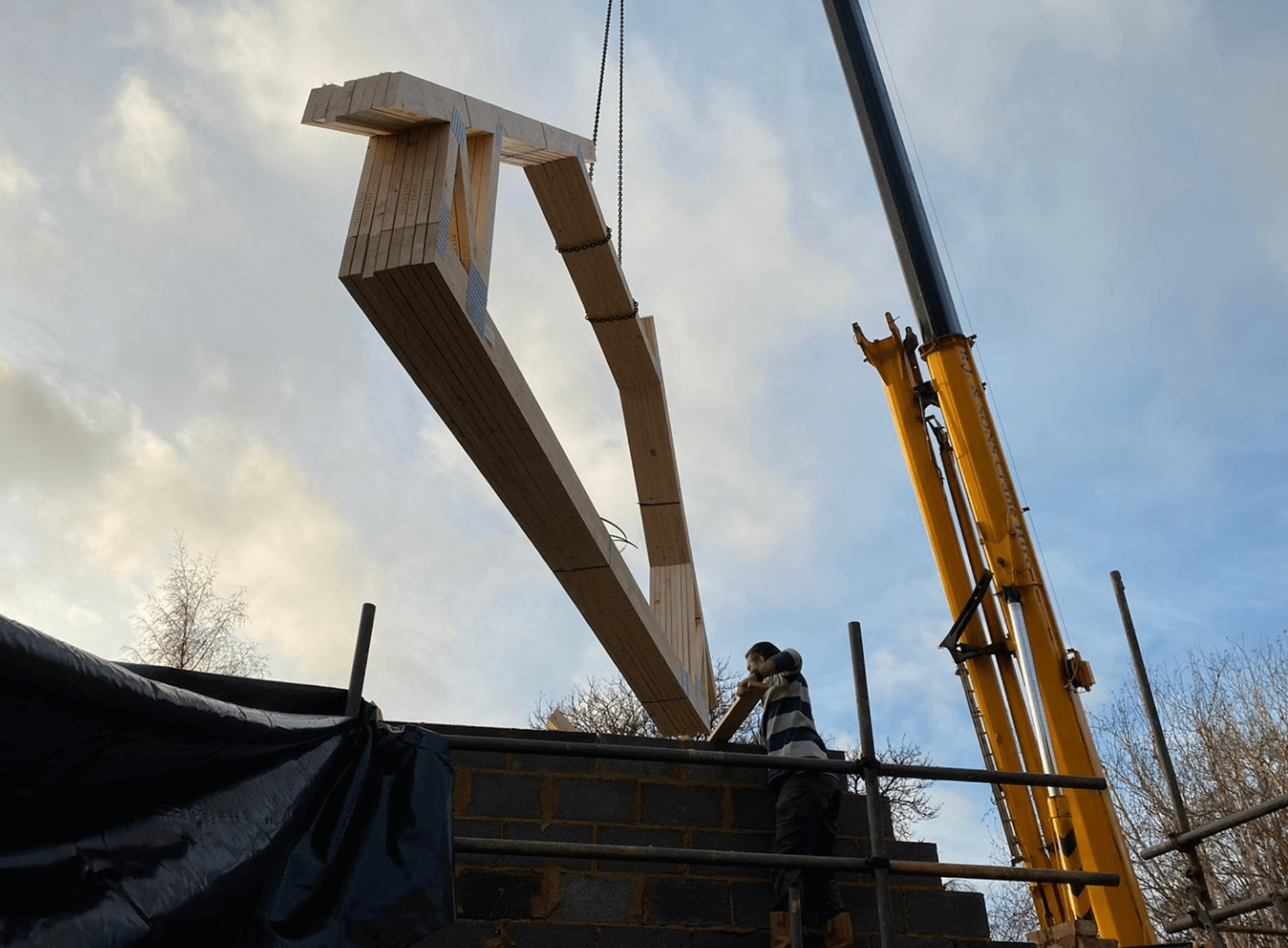 attic trusses being craned onto a home