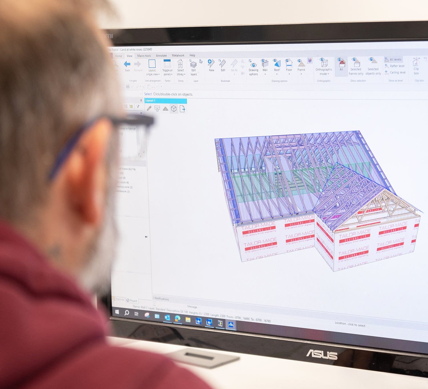 A roof truss designer working on a computer