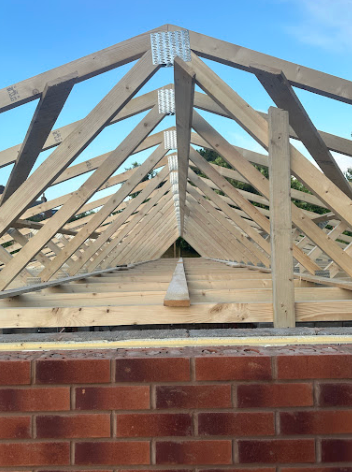 wooden roof trusses installed on a home