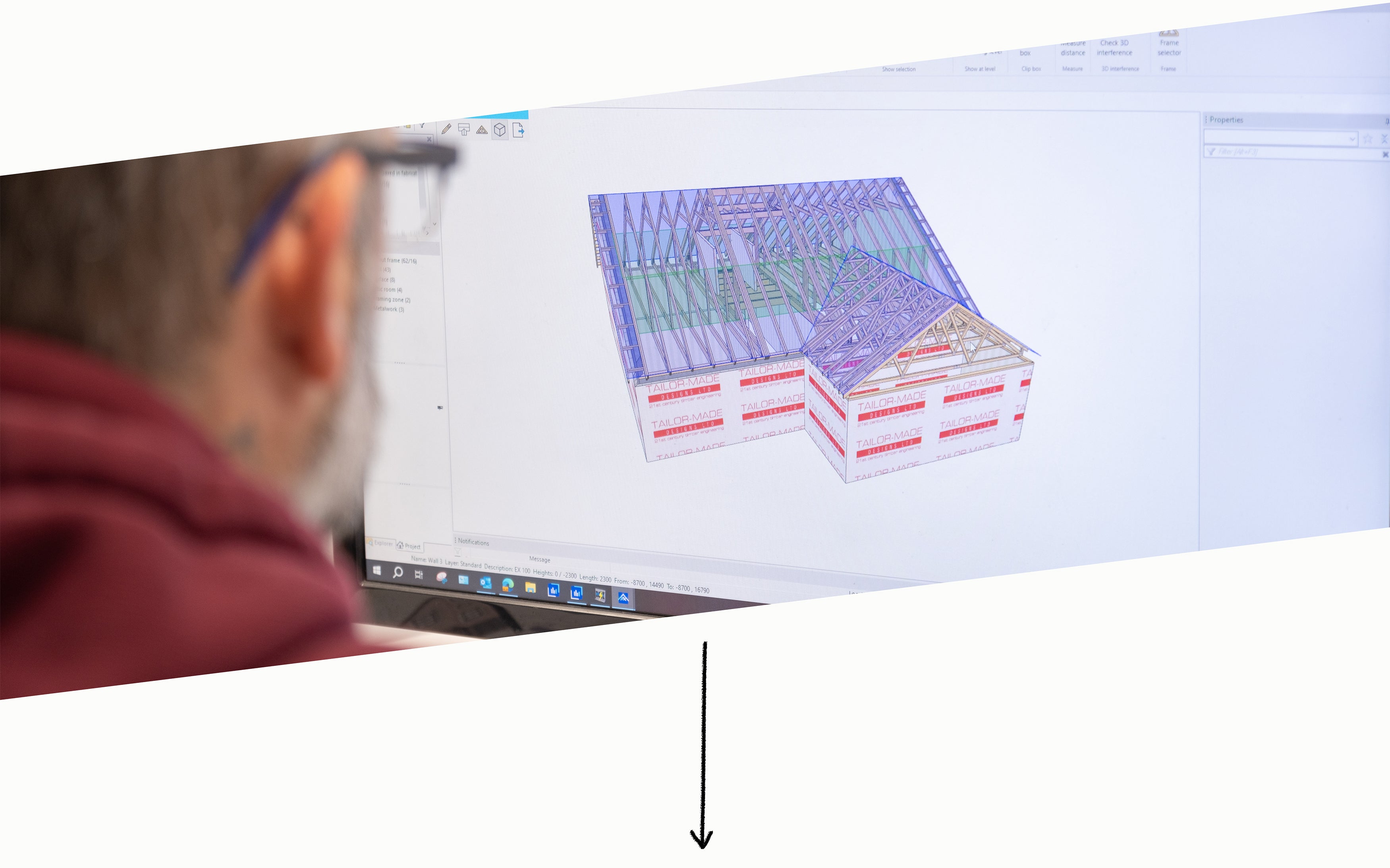 A roof truss designer working on a computer