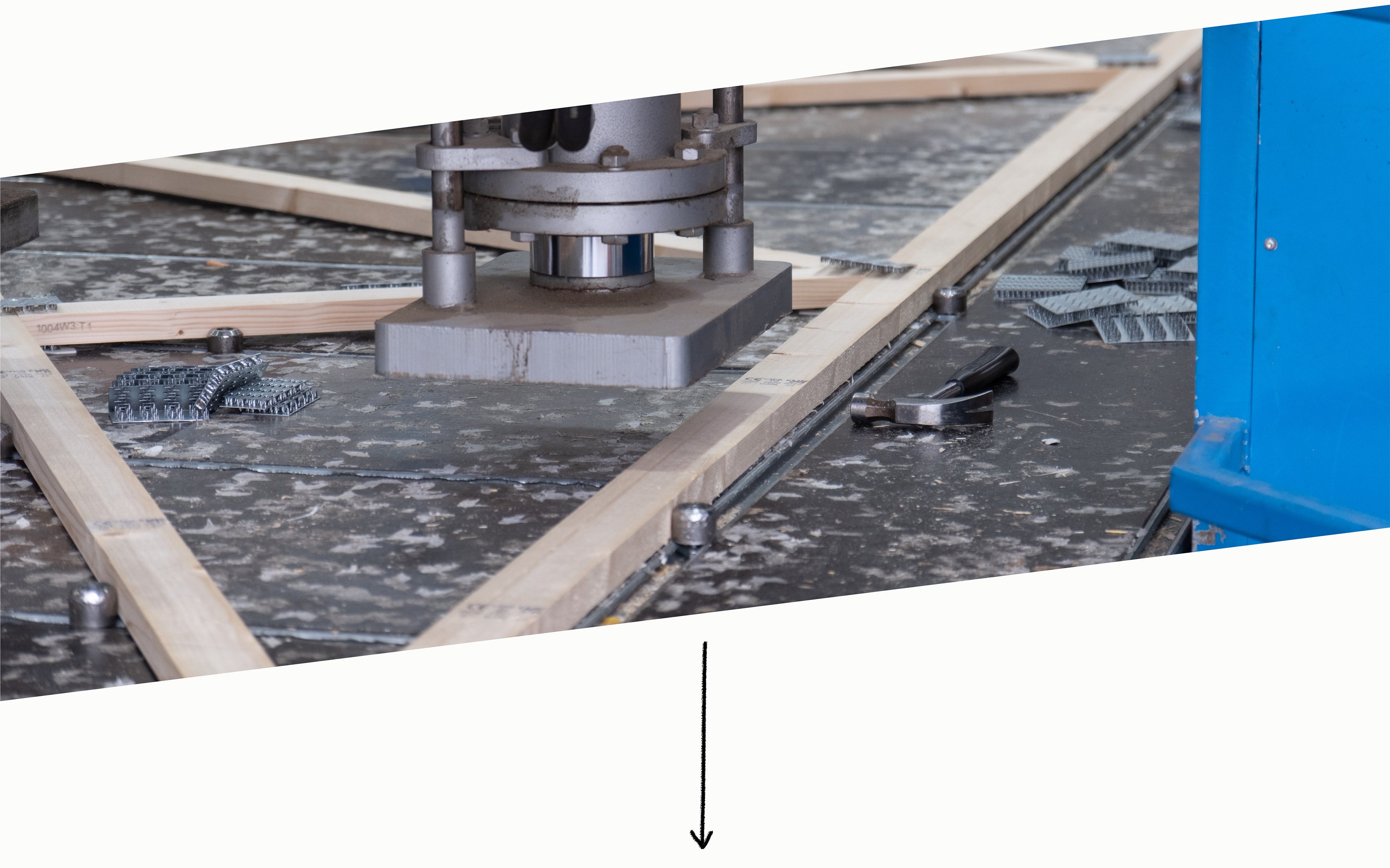 a hydraulic press pushing nailplates into roof trusses