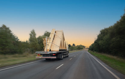 trusses and joists on a lorry driving along a road